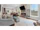 Open concept living room with stone fireplace, hardwood floors, and stylish furnishings at 2610 Cheney St, Atlanta, GA 30344