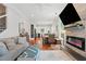 Bright living room featuring a stone fireplace, hardwood floors, and open layout to the kitchen at 2610 Cheney St, Atlanta, GA 30344