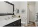 Cozy bathroom with a single sink vanity, a large decorative mirror, and a shower with a stylish curtain at 2610 Cheney St, East Point, GA 30344