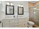 Bathroom with double vanity, granite countertops, and glass-enclosed shower at 2610 Cheney St, East Point, GA 30344