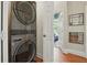 Laundry area with stacked washer and dryer and view into a bedroom at 2610 Cheney St, East Point, GA 30344