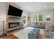 Comfortable living room featuring a stone fireplace, ample natural light, and a welcoming atmosphere at 2610 Cheney St, East Point, GA 30344