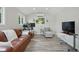 Finished ' Shed' with a seating arrangement, desk, and hardwood floors at 2610 Cheney St, East Point, GA 30344