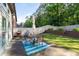 Outdoor patio seating area with a grill and manicured lawn at 2800 Tuscany Park Dr, Lawrenceville, GA 30043