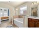 Well-lit bathroom showcasing a soaking tub, a dark wood vanity, and a separate shower stall at 2800 Tuscany Park Dr, Lawrenceville, GA 30043