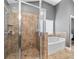 Elegant bathroom featuring a glass-enclosed shower and a separate tub for luxurious bathing at 2800 Tuscany Park Dr, Lawrenceville, GA 30043