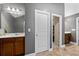 Spacious bathroom with dual sinks, well-lit vanity, and doorway leading to a closet at 2800 Tuscany Park Dr, Lawrenceville, GA 30043
