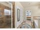 Bright bathroom features a tiled shower, soaking tub, and a doorway leading into the primary bedroom at 2800 Tuscany Park Dr, Lawrenceville, GA 30043