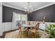 Bright dining area with a marble table, stylish gold chandelier and modern white sideboard at 2800 Tuscany Park Dr, Lawrenceville, GA 30043