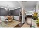 Elegant dining room featuring hardwood floors, stylish chandelier, and an open view to the living area at 2800 Tuscany Park Dr, Lawrenceville, GA 30043