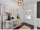 Welcoming foyer showcasing hardwood floors, decorative console table, and elegant lighting fixtures at 2800 Tuscany Park Dr, Lawrenceville, GA 30043