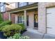 Inviting front porch with stylish columns, manicured shrubs, and a charming wreath on the front door at 2800 Tuscany Park Dr, Lawrenceville, GA 30043