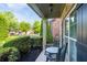 Cozy front porch with rocking chairs, lush shrubs, and tasteful decor, perfect for relaxing outdoors at 2800 Tuscany Park Dr, Lawrenceville, GA 30043