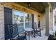 Comfortable front porch featuring rocking chairs, a small table, and serene views, ideal for enjoying the outdoors at 2800 Tuscany Park Dr, Lawrenceville, GA 30043