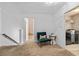 Bright upstairs hallway with carpet, chair, laundry room access, and railing, offering practical home living at 2800 Tuscany Park Dr, Lawrenceville, GA 30043