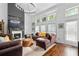 Cozy living room with a fireplace, high ceilings and large windows offering natural light at 2800 Tuscany Park Dr, Lawrenceville, GA 30043
