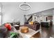 Bright living room with an open floor plan to the kitchen, high ceilings, and a modern chandelier at 2800 Tuscany Park Dr, Lawrenceville, GA 30043