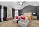 Spacious main bedroom featuring plush seating, neutral tones, ample natural light, and elegant decor at 2800 Tuscany Park Dr, Lawrenceville, GA 30043