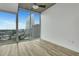 Bedroom boasting city views from large windows and light wood-look flooring at 3324 Peachtree Ne Rd # 2004, Atlanta, GA 30326
