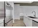 Well-lit kitchen showcasing stainless steel appliances, white cabinetry, and a breakfast bar at 3324 Peachtree Ne Rd # 2004, Atlanta, GA 30326