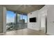 Bright living room with a large window, concrete ceiling and wall-mounted TV at 3324 Peachtree Ne Rd # 2004, Atlanta, GA 30326