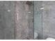 Modern shower featuring glass doors, contemporary fixtures, and marble-look tiling at 3324 Peachtree Ne Rd # 2004, Atlanta, GA 30326
