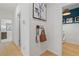 Hallway with coat rack, interior door, and view of in-unit laundry room with washer and dryer at 408 Hatcher Ct, Hampton, GA 30228