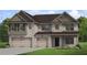 Beautiful new construction home featuring a three-car garage and a brick facade at 408 Hatcher Ct, Hampton, GA 30228