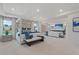 Open-concept main bedroom with a stylish canopy bed, connected living area, and modern decor at 408 Hatcher Ct, Hampton, GA 30228
