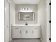 Bathroom with white vanity, patterned flooring, modern light fixture, and black hardware at 5427 Fieldgreen Dr, Stone Mountain, GA 30088