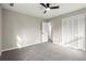 Spacious bedroom featuring neutral colors, plush carpet, and a ceiling fan at 5427 Fieldgreen Dr, Stone Mountain, GA 30088
