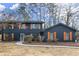 Charming two-story home featuring a dark blue exterior and decorative wooden shutters at 5427 Fieldgreen Dr, Stone Mountain, GA 30088