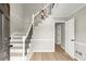 Bright foyer showcasing a staircase with modern iron railings and wood flooring at 5427 Fieldgreen Dr, Stone Mountain, GA 30088