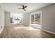 Open-concept living room boasts stylish flooring, neutral paint, and sliding glass doors to the backyard at 5427 Fieldgreen Dr, Stone Mountain, GA 30088