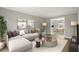 Well-lit living room with comfortable seating and an open view to the dining area at 5427 Fieldgreen Dr, Stone Mountain, GA 30088