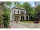 Charming two-story home with white siding, black trim, manicured landscaping, and a welcoming front porch at 357 Mell Ave, Atlanta, GA 30307