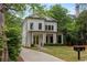 Charming two-story home with white siding, black trim, manicured landscaping, and a welcoming front porch at 357 Mell Ave, Atlanta, GA 30307