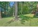 A spacious backyard with well-maintained lawn and a view of mature trees at 3592 Midvale Cv, Tucker, GA 30084