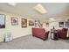 Finished basement with neutral carpet, painted panel walls, and red couches at 3592 Midvale Cv, Tucker, GA 30084