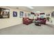 Finished basement with neutral carpet, painted panel walls, and red couches at 3592 Midvale Cv, Tucker, GA 30084