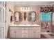 Bathroom featuring dual sinks, attractive mirrors, and window at 3592 Midvale Cv, Tucker, GA 30084