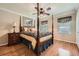 Bedroom with hardwood floors, ceiling fan, bedside table, and bright windows at 3592 Midvale Cv, Tucker, GA 30084