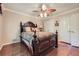 A bedroom featuring a wooden bed with patterned comforter and hardwood floors at 3592 Midvale Cv, Tucker, GA 30084