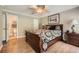 Comfortable bedroom features ceiling fan, hardwood floors, and attached bathroom at 3592 Midvale Cv, Tucker, GA 30084