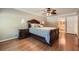 Bedroom features hardwood floors, ceiling fan, bedside tables, and attached bathroom at 3592 Midvale Cv, Tucker, GA 30084