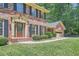 Beautiful brick home with well-maintained lawn and a two-car garage, nestled among mature trees at 3592 Midvale Cv, Tucker, GA 30084
