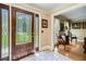 Inviting foyer featuring tile flooring, decorative glass door and sidelights, adjacent to a sitting room at 3592 Midvale Cv, Tucker, GA 30084