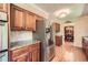 An open kitchen with stainless steel refrigerator, granite counters, tile backsplash, and hardwood floors at 3592 Midvale Cv, Tucker, GA 30084