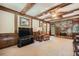 Cozy living room displaying a brick fireplace, beamed ceilings, and plush seating at 3592 Midvale Cv, Tucker, GA 30084