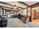 A stylish living room featuring beamed ceilings, rich wood trim, and large windows at 3592 Midvale Cv, Tucker, GA 30084